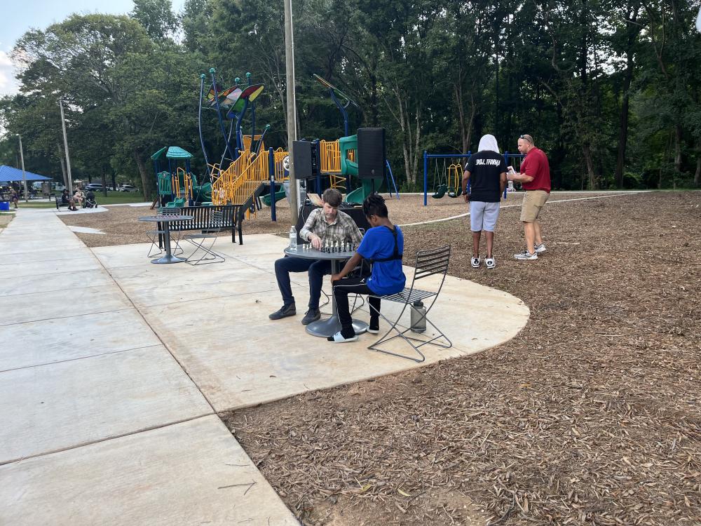 Image of Fred Alexander opening and two people playing chess.