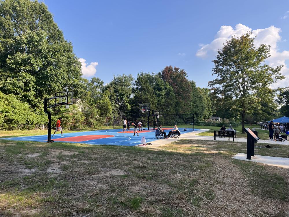 Image of people playing basketball at Fred Alexander park opening.