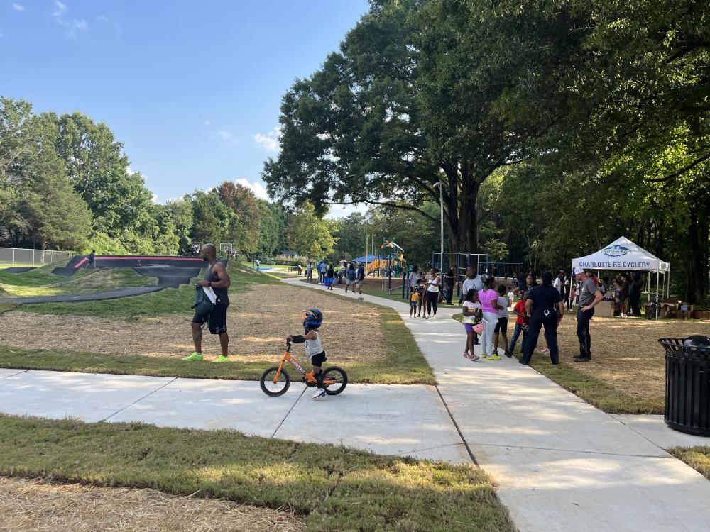 Image of Fred Alexander opening and child on bike approaching pump track.